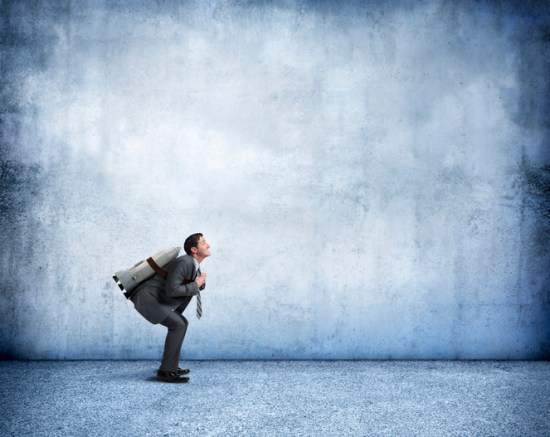 Businessman With Rocket Strapped To His Back